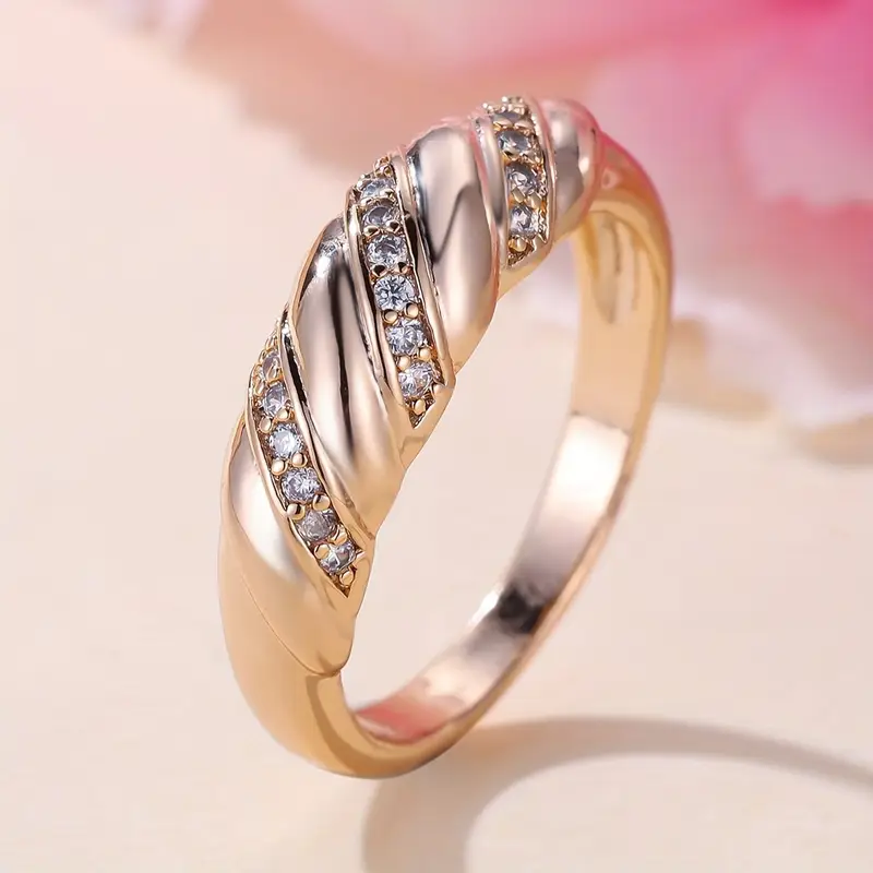 Woven ring with pink elements and zirconia