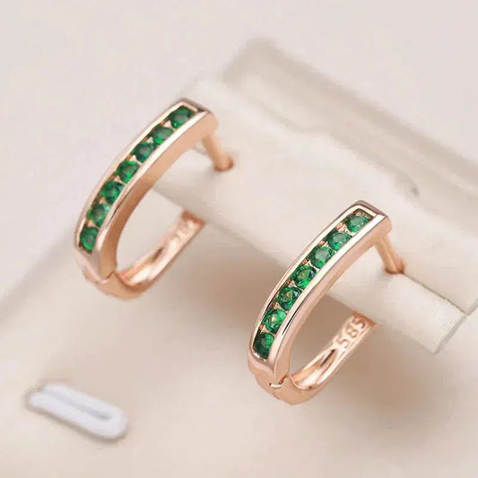 Elegant earrings with green crystals set in gold
