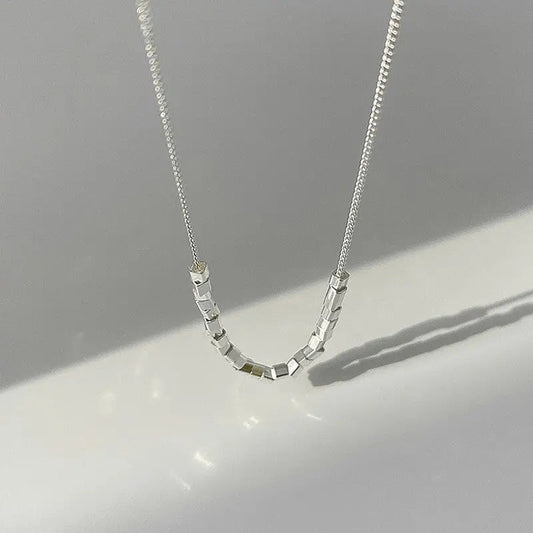 Modern pearl-inspired necklace with a sleek chain design