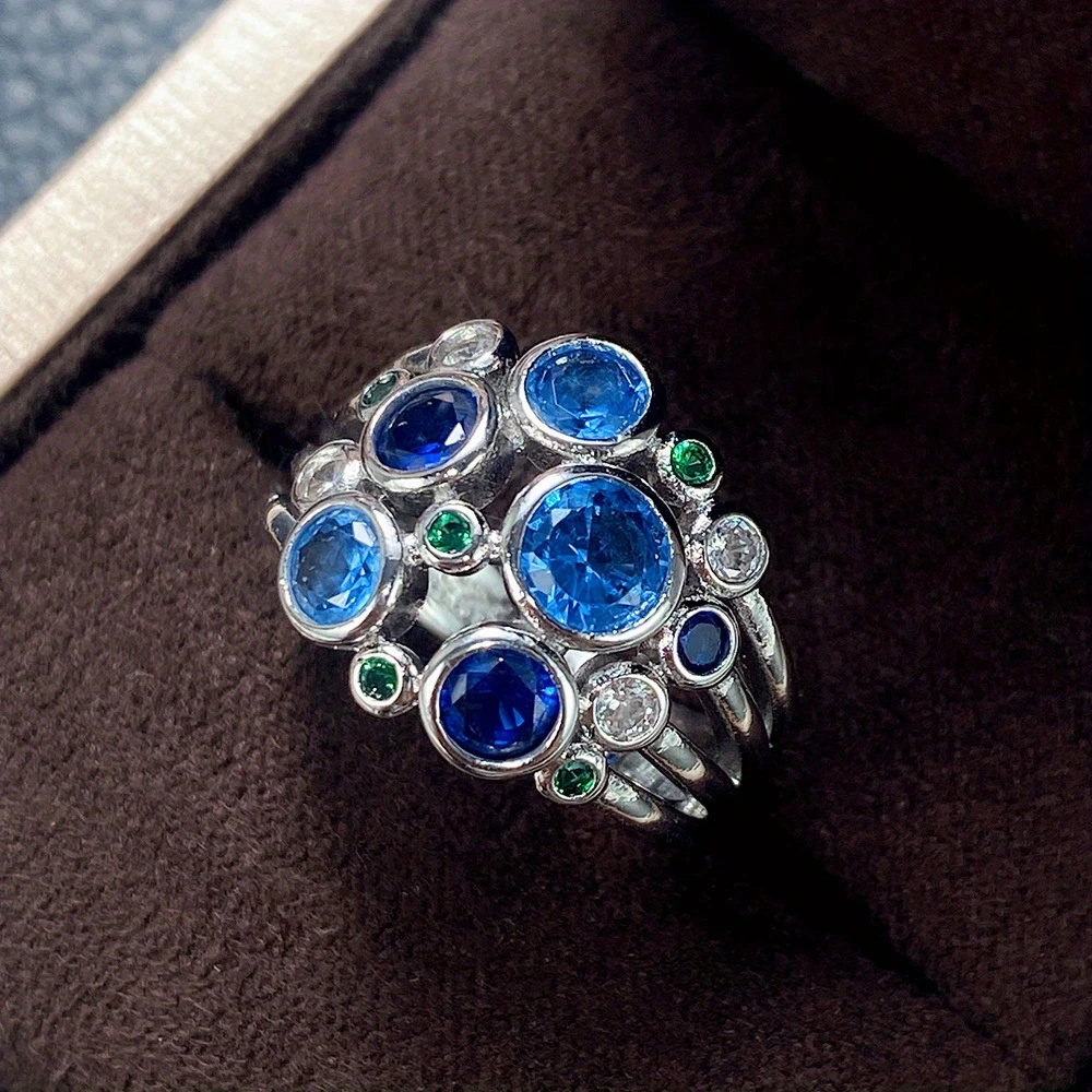 Silver ring with green and blue bubbles