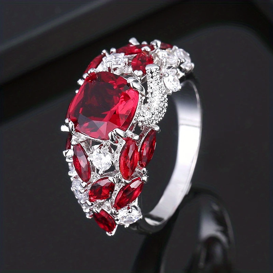 Silver ring with many red crystals